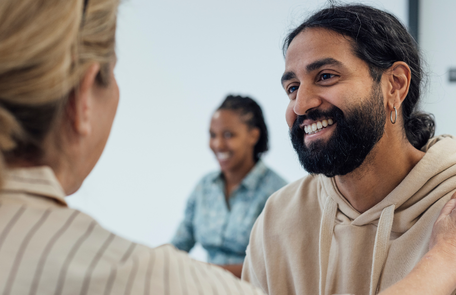 Young male looking happy receiving some good news in a hospital
